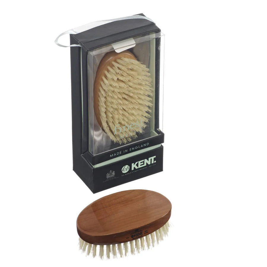 Travel hairbrush with round wooden handle and light bristles, in clear travel case.