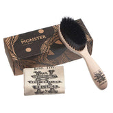 Hairbrush with curved wooden handle, black bristles, and patterned storage pouch