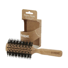 Hair brush with light wood handle and black bristles, shown with Pure Flow box