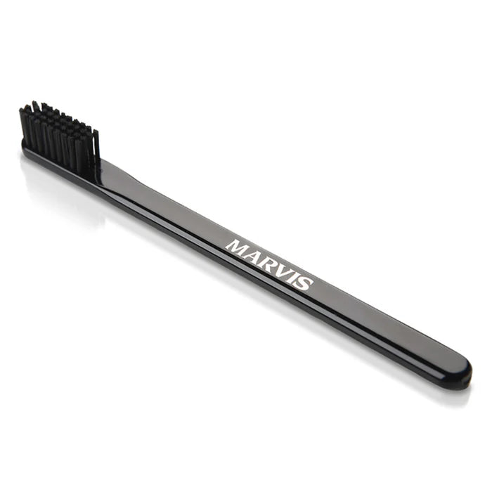 Black Marvis toothbrush with angled bristles and MARVIS logo