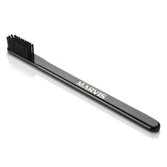 Black Marvis toothbrush with angled bristles and MARVIS logo