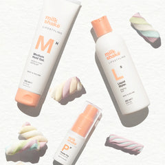Hair shaping liquid styler bottles, white with orange caps, multiple sizes shown.