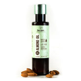Almond oil bottle with green cap and cream label, 100 ml