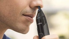 Philips nose trimmer held at the edge of the nostril