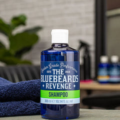 Blue shampoo bottle on a surface, with white cap and The Bluebeards Revenge Shampoo label, 300 ml