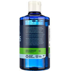Blue shampoo bottle with white cap, showing back label text and barcode area