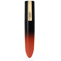 Lip gloss tube with black cap and gold label, warm brown-red shade.