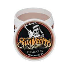 Clay pomade jar with white lid and round black label featuring skull graphic