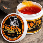 Suavecito firm hold pomade jar with open lid and amber gel