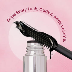 Precision mascara wand spreading black gel from a silver bottle