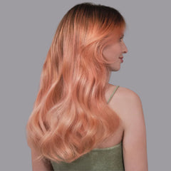 Peach blush long wavy hair on woman, side view