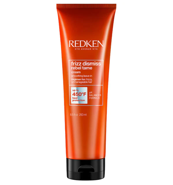 Hair frizz-dismissing cream tube, red with black cap and REDKEN label