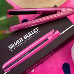 Pink mini hair straightener on box, logo and iron plates visible
