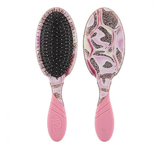 Pink oval hair detangling brush with black bristle pad and speckled underside