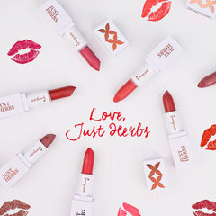 Multiple pink mini lipsticks with white brand boxes arranged on a flat surface
