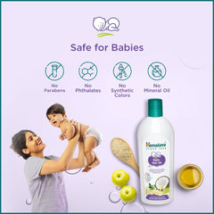 Himalaya Baby Hair Oil bottle with safety icons and small oil jar.