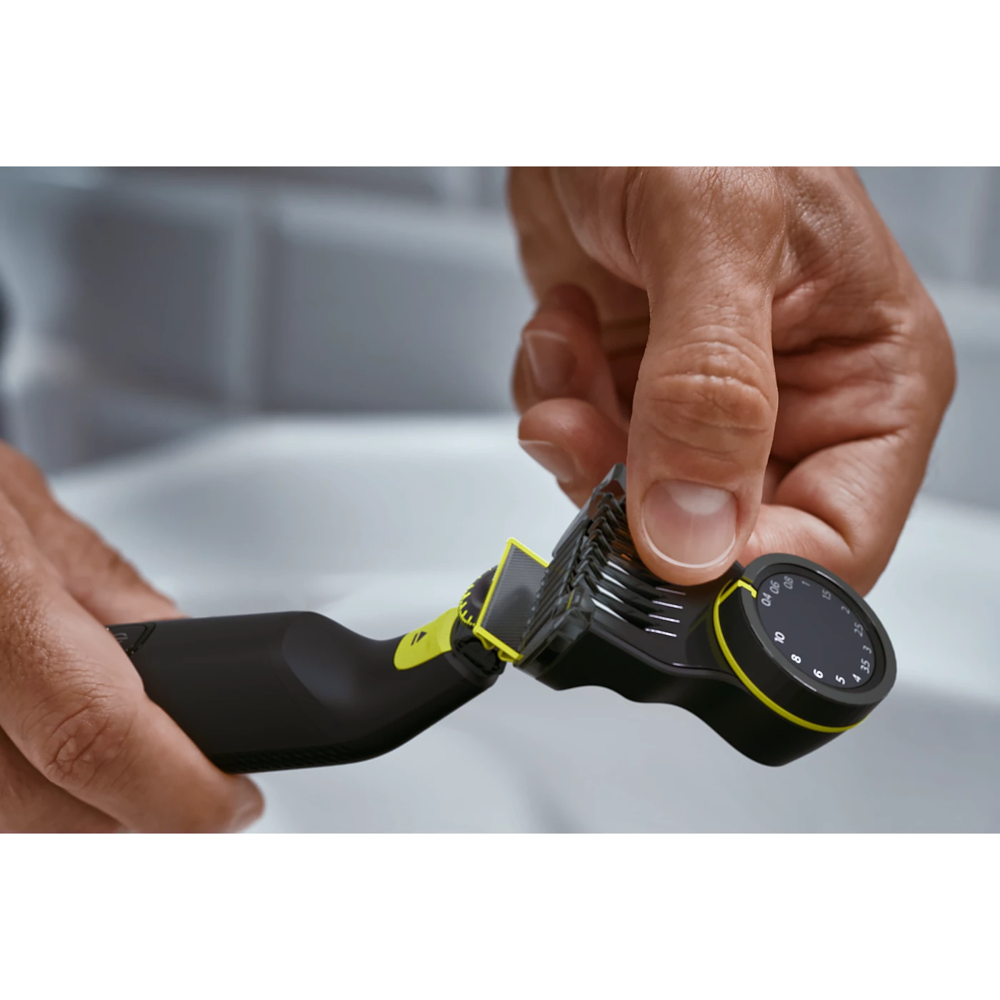 Hand using electric OneBlade trimmer on stubble with adjustable guard