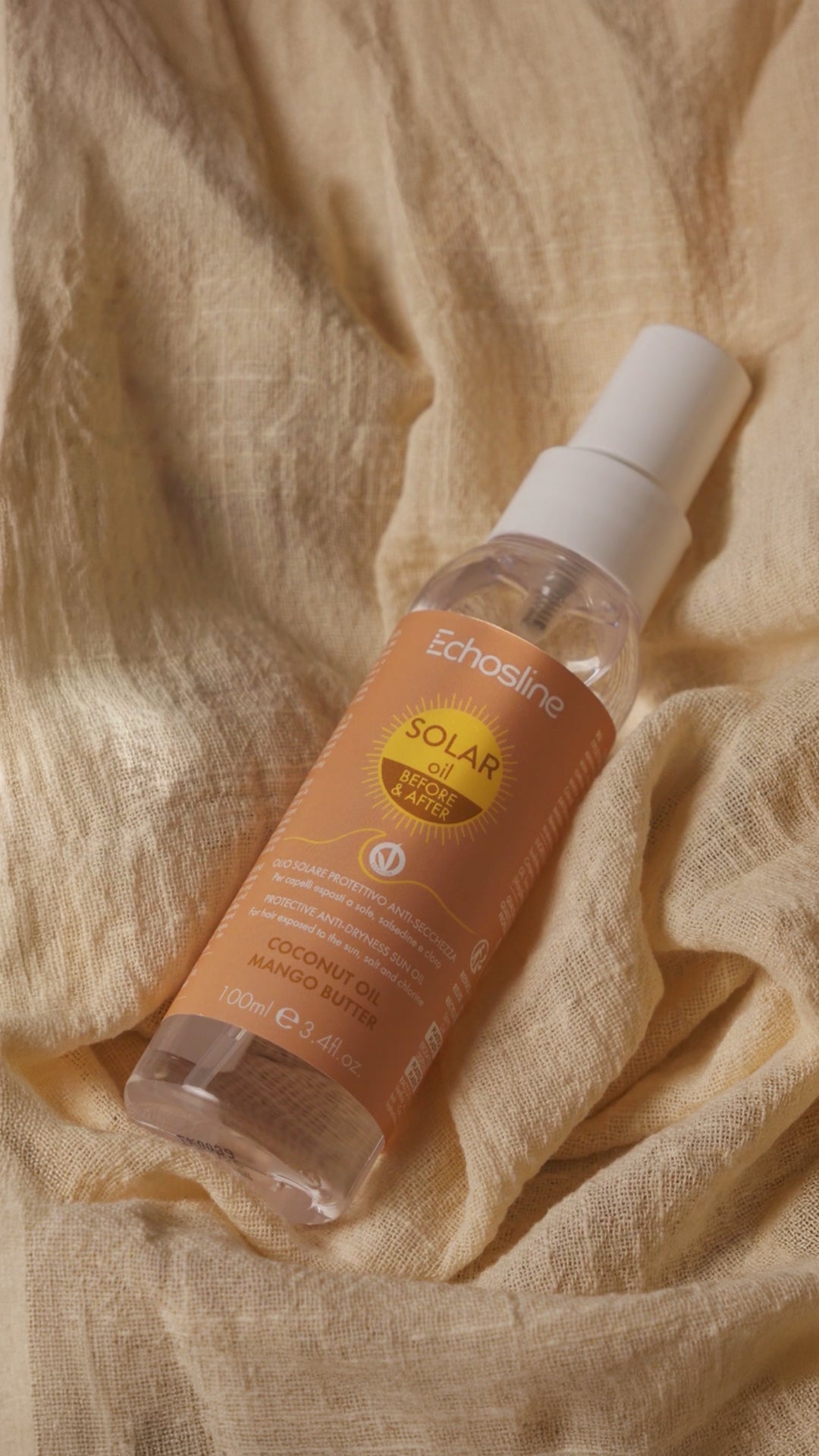 Solar oil spray bottle for hair, clear bottle with peach-brown label