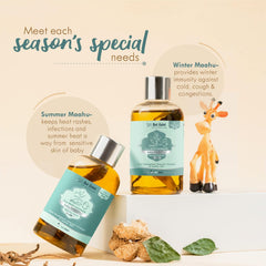 Baby massage oil bottles with silver caps, teal labels, and amber oil