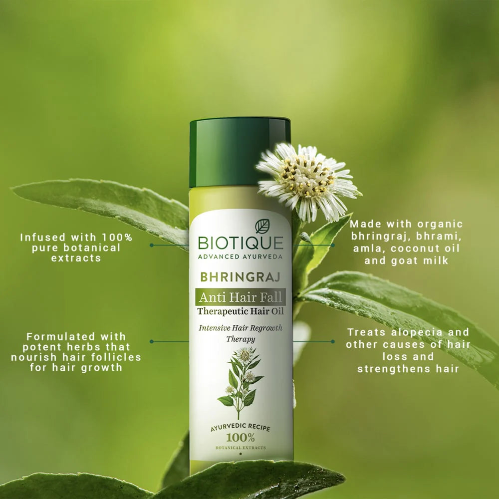 Biotique Bhringraj anti hair fall therapeutic oil bottle with bhringraj leaves and flowers
