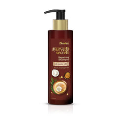 Ayurveda Secrets repairing shampoo bottle with pump, dark maroon and gold label.