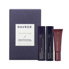 Davroe hair care trio pack: two dark bottles and one red tube in a navy gift box