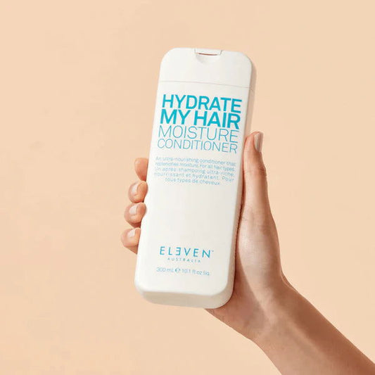 Moisture conditioner bottle held in hand, front label visible, 300 ml