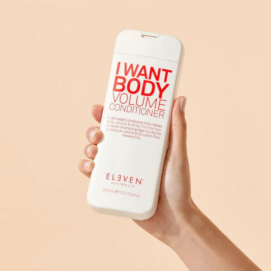 Eleven Australia body volume conditioner bottle, 300ml, held in hand