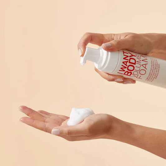 Hands dispensing body volume foam from I Want Body Volume Foam bottle