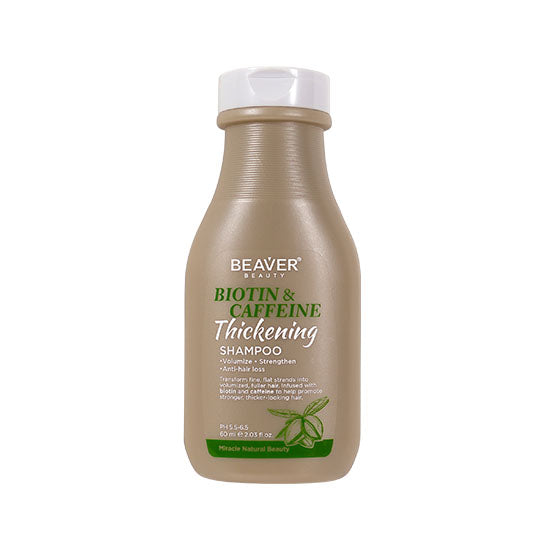 Shampoo bottle with white cap, beige label featuring green Biotin & Caffeine text