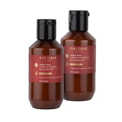 Travel-size Amber Rose hydrating hair duo: shampoo and conditioner bottles, amber brown.