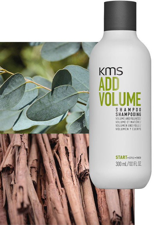 Shampoo bottle with white label reading KMS Add Volume and Volume shampoo