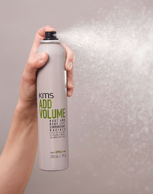 Hand holding hair volume treatment bottle with KMS Add Volume label, 200 ml