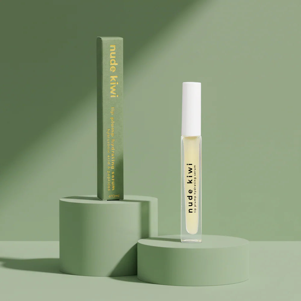 Lip hydrating serum tube with pale yellow applicator, shown on blocks.