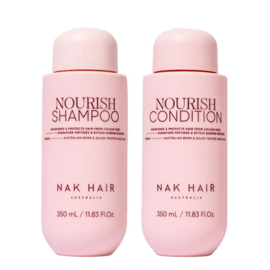 NAK Hair Nourish shampoo and conditioner bottles, pink 350 mL each, red caps
