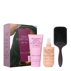 Hair care hero pack with NAK Hair products and black hairbrush, includes spray and cream.