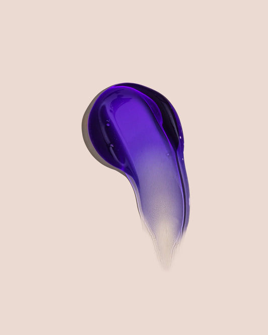 Purple shampoo gel swatch in a drop shape