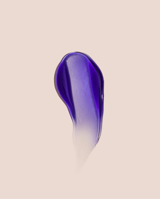 Purple shampoo drop with lighter streak, no label visible.