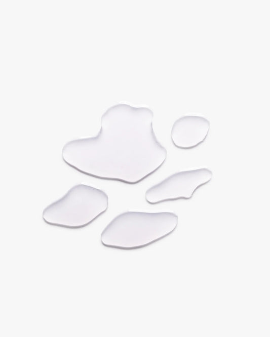 Blonde hair serum swatch shapes on light background