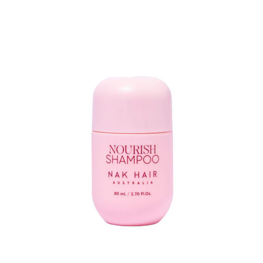 Travel-size Nourish Shampoo bottle, pink with NOURISH SHAMPOO and NAK HAIR text
