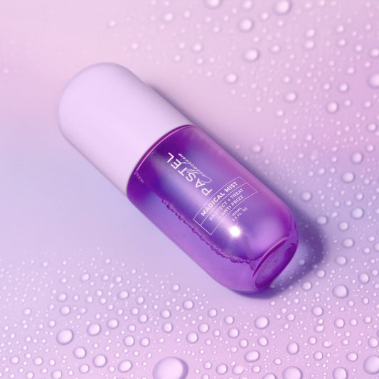 Angled close-up of purple hair mist bottle with clear spray nozzle and label.