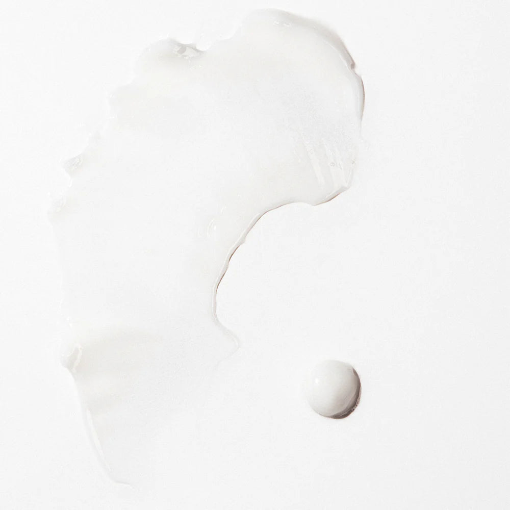 Pale white styling cream swatch with smooth, glossy texture