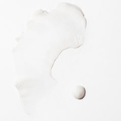 Pale white styling cream swatch with smooth, glossy texture