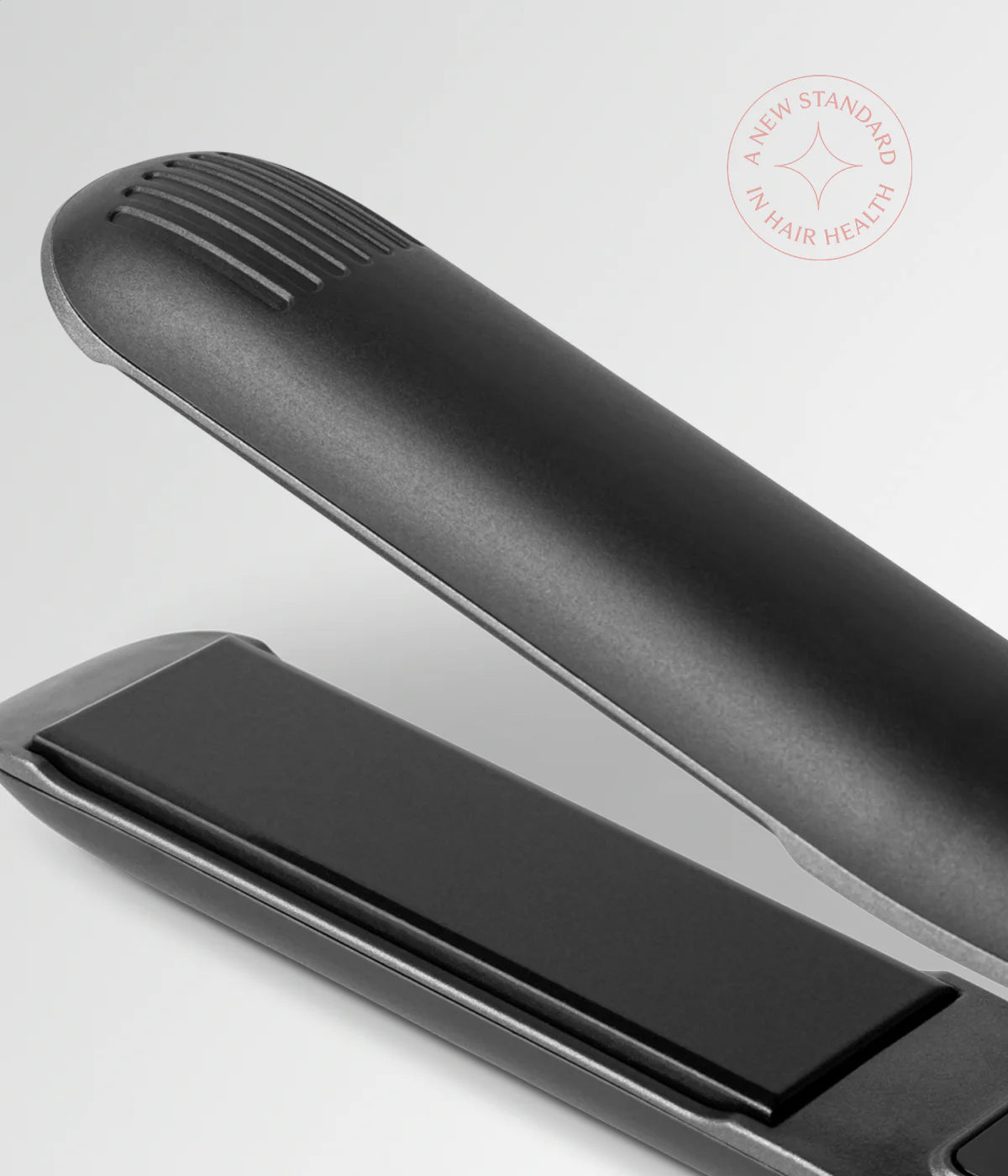 Close view of black hair straightener plates with vented top bar