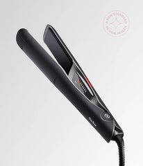 Black hair straightener with vented barrel and side control buttons, cord attached