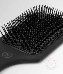 Black cushion hair brush with curved edge and pin-filled cushion pad