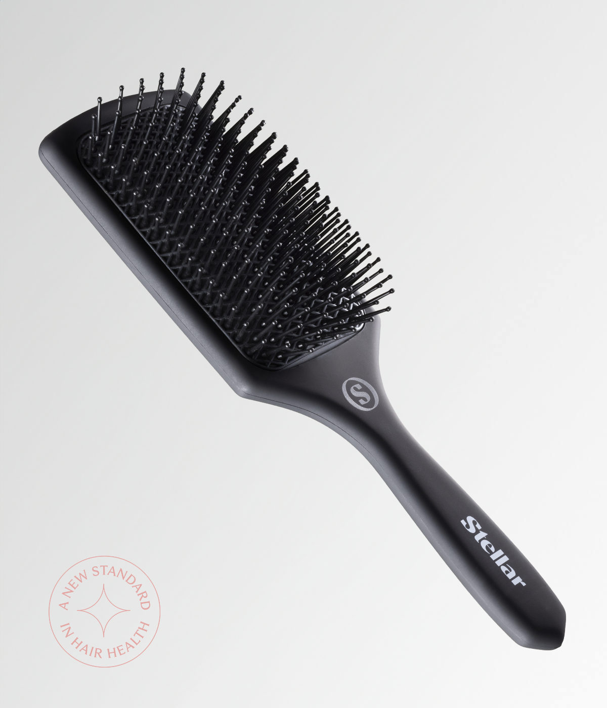 Black cushion hair brush with short rounded pins and ergonomic handle