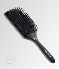 Black cushion hair brush with short rounded pins and ergonomic handle