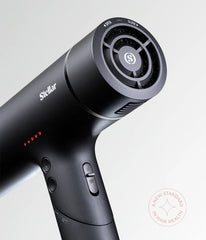 Black hair dryer handle with control buttons and circular inlet grille