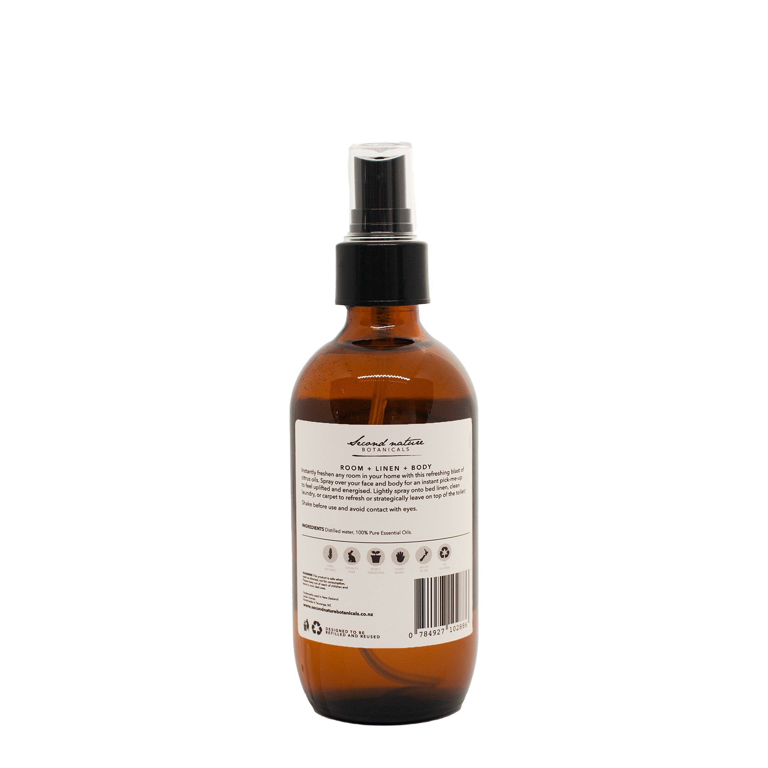 Amber glass room spray bottle with black pump, back label and barcode